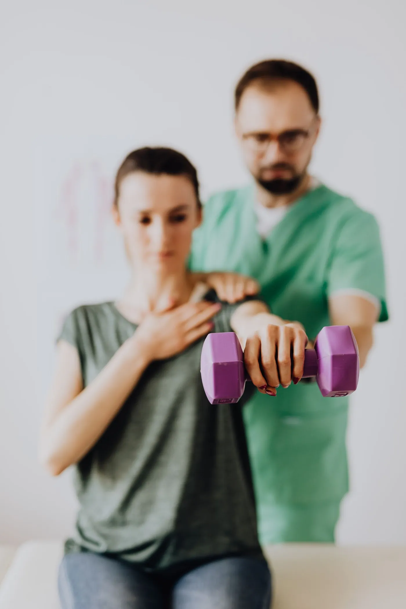 A physiotherapist guiding a patient through an exercise