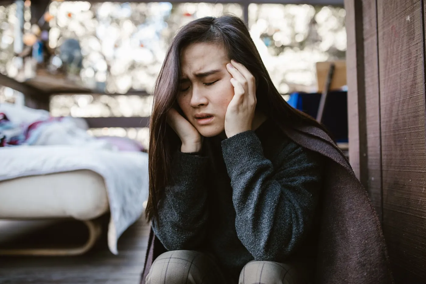 A woman holding her head in severe pain